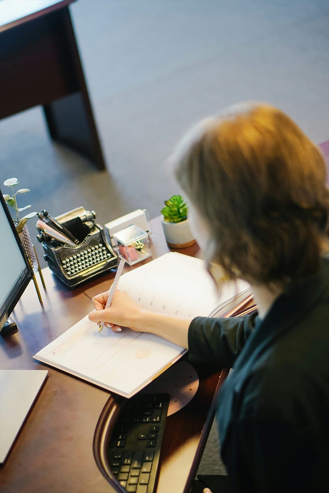Insurance professional completing paperwork at a desk